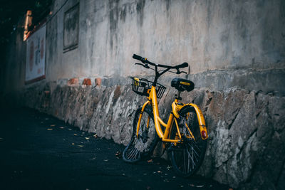 Bicycle parked against wall