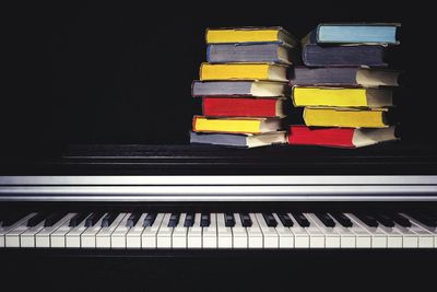 Close-up of piano keys over black background