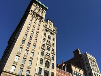 Low angle view of buildings against clear blue sky