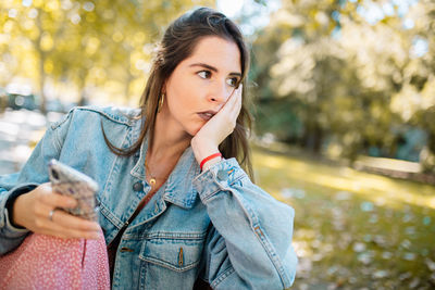 Portrait of beautiful young woman in city