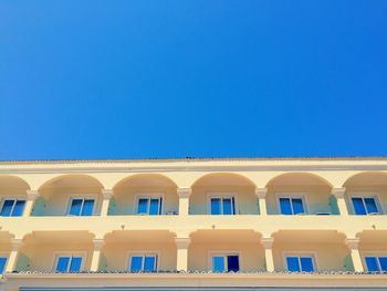 Low angle view of building against clear blue sky