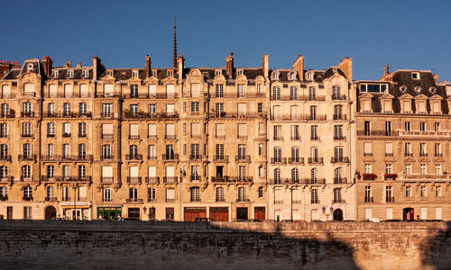 Buildings in city against clear sky