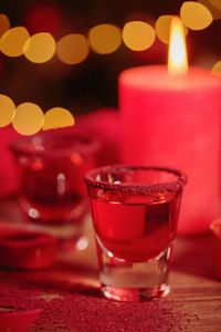 Close-up of illuminated tea light on table