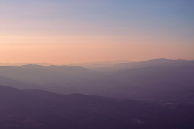 Scenic view of silhouette mountains against sky during sunset