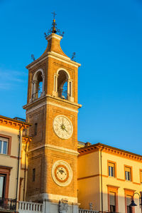 Low angle view of clock tower against sky