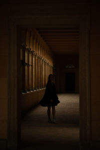 Woman walking in corridor of building