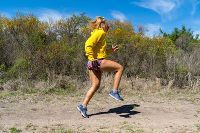 Woman running in the forrest. young blond woman running in the forrest on a warm summer day.