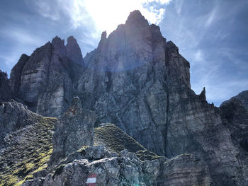 Low angle view of rocky mountains against sky