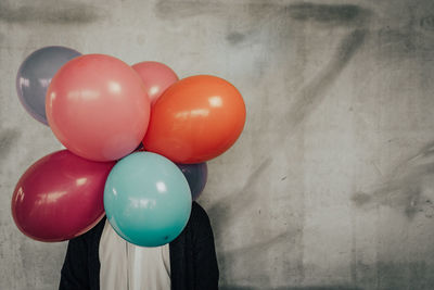 Close-up of multi colored balloons against wall