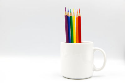 Close-up of colorful drinking straws against white background