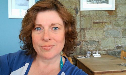 Close-up portrait of mature woman sitting in restaurant