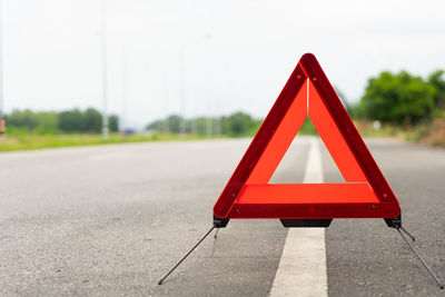 Close-up of warning sign on road