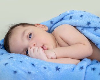 Portrait of cute baby boy sleeping on bed