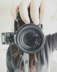 Low section of woman holding camera