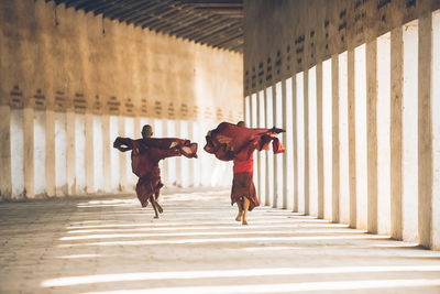 Rear view of men walking in corridor