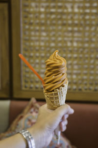 Hand holding ice cream cone