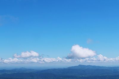 Scenic view of mountains against blue sky