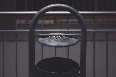 Burnt cigarettes on railing