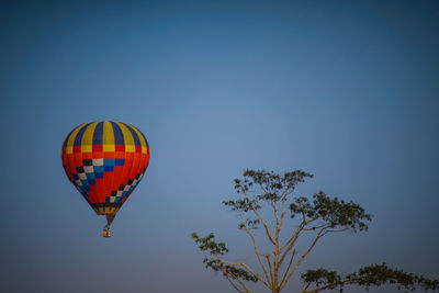 Low angle view of hot air balloon against clear blue sky