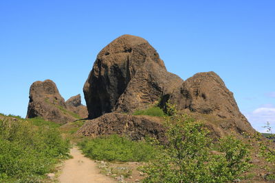 Rock formation against clear blue sky