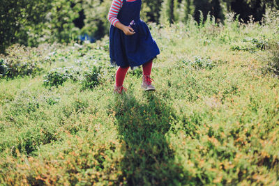 Woman standing on grassy field