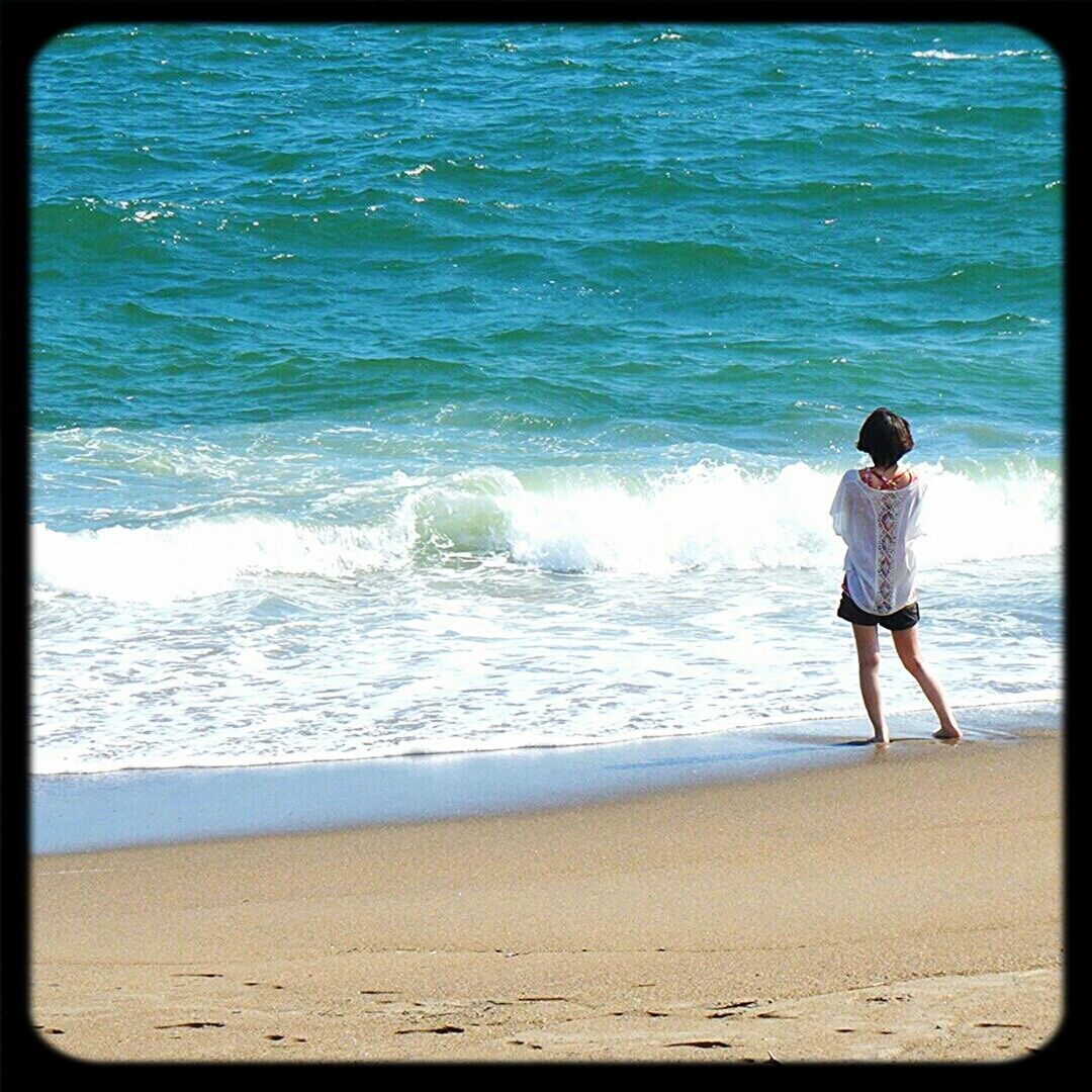 sea, water, beach, shore, wave, full length, leisure activity, surf, lifestyles, horizon over water, sand, vacations, transfer print, auto post production filter, standing, childhood, nature, beauty in nature