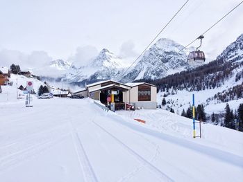 Ski lift over snow covered mountains