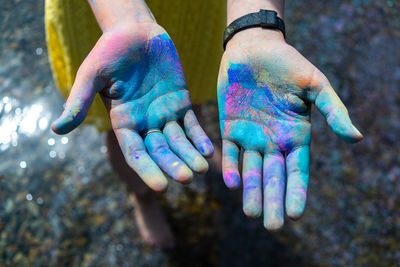 Low section of woman holding powder paint during holi festival