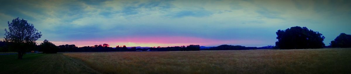 Panoramic view of field against sky during sunset