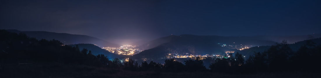 Scenic view of silhouette mountains against sky at night