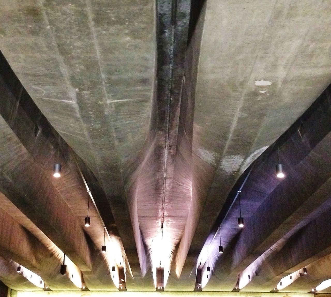 architecture, ceiling, illuminated, indoors, built structure, lighting equipment, low angle view, architectural column, night, arch, modern, in a row, travel, transportation, architectural feature, diminishing perspective, city, building, city life, travel destinations