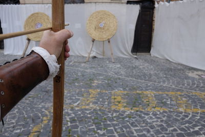 Cropped hand of archer aiming at target