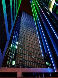 Low angle view of illuminated skyscraper at night