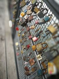 Close-up of padlocks on metal grate