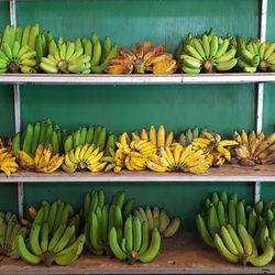 Bananas on wooden shelf for sale at market