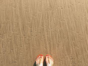 Low section of woman standing on tiled floor