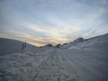 Scenic view of snow covered mountains against sky