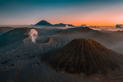 Panoramic view of volcanic landscape against sky during sunset