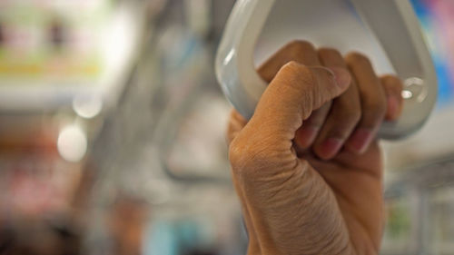 Close-up of man holding glass