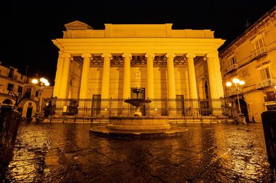 Fountain in city at night