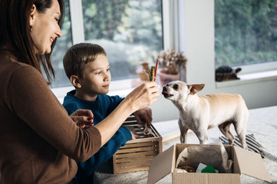 Support local business, small business. pet shop owner, mom and kid putting bone in pet