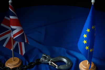 Close-up of flags with chain and lock on table