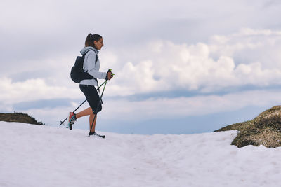 Passionate girl of outdoor sports during walking on the snow