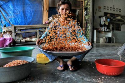 Full length of worker cleaning food in kitchen