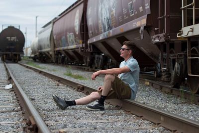 Young woman sitting on train at railroad station