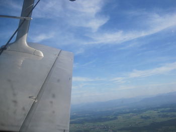 Airplane flying over clouds against sky