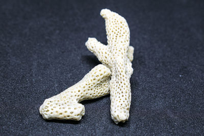 Close-up of bananas on table against black background