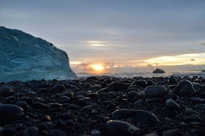 Scenic view of beach against sky during sunset