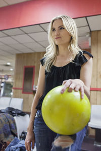 A young woman with a bowling ball.