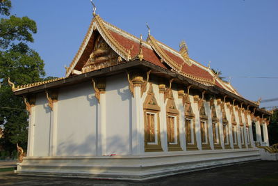 Low angle view of temple building against clear blue sky